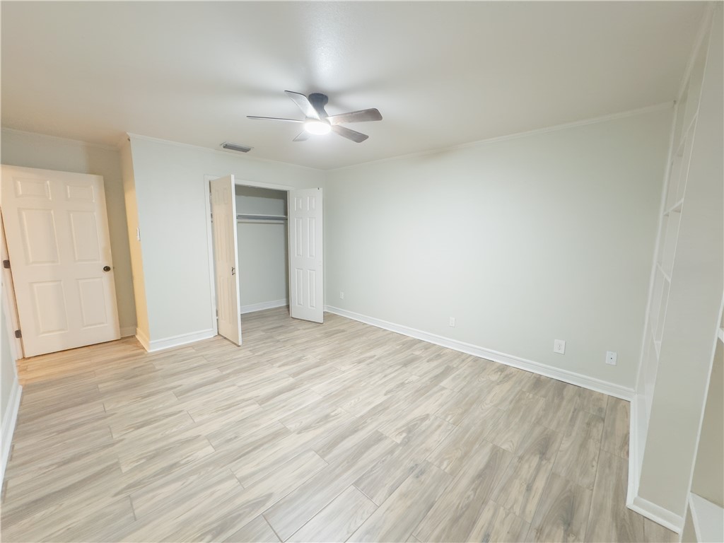 6702 Sahara Drive Corpus Christi, TX 78412 - Photo 14 of 30 an empty room with wooden floor and windows