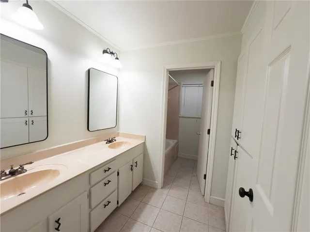 a spacious bathroom with a double vanity sink mirror and double