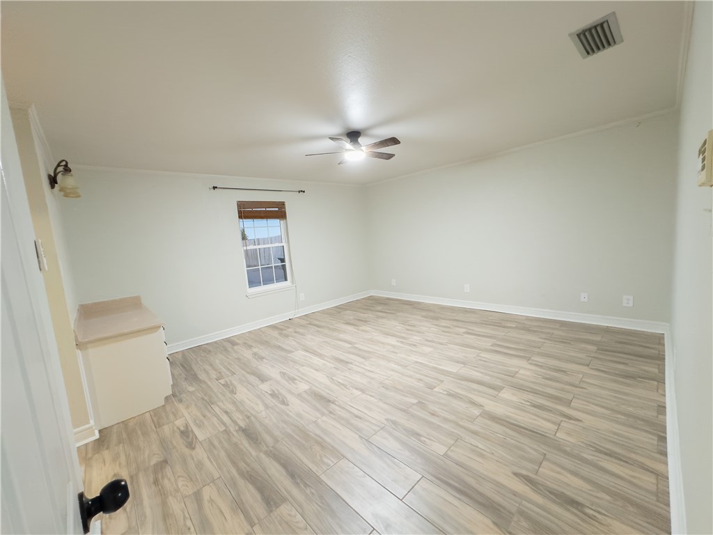6702 Sahara Drive Corpus Christi, TX 78412 - Photo 16 of 30 an empty room with wooden floor and windows