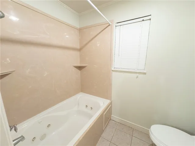 a bathroom with a bathtub and a toilet