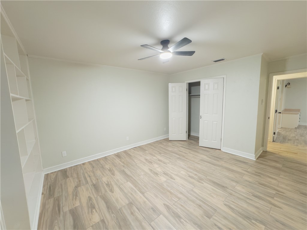 6702 Sahara Drive Corpus Christi, TX 78412 - Photo 25 of 30 a view of an empty room with wooden floor and a ceiling fan