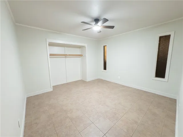 a view of a livingroom with a ceiling fan and window