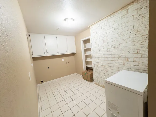 a bedroom with a bed and a white wall