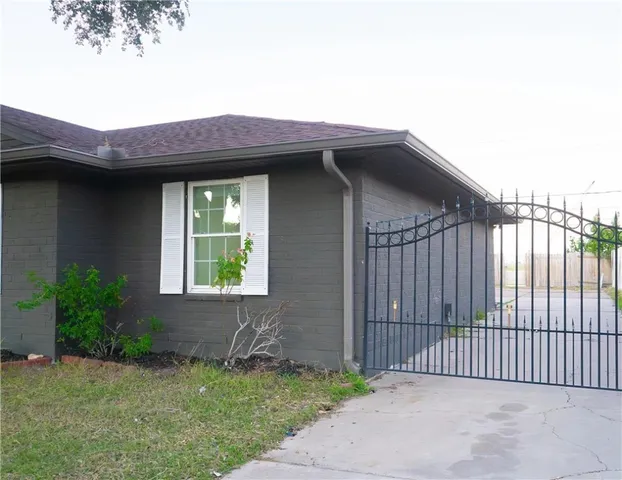 a view of a house with a small yard and plants