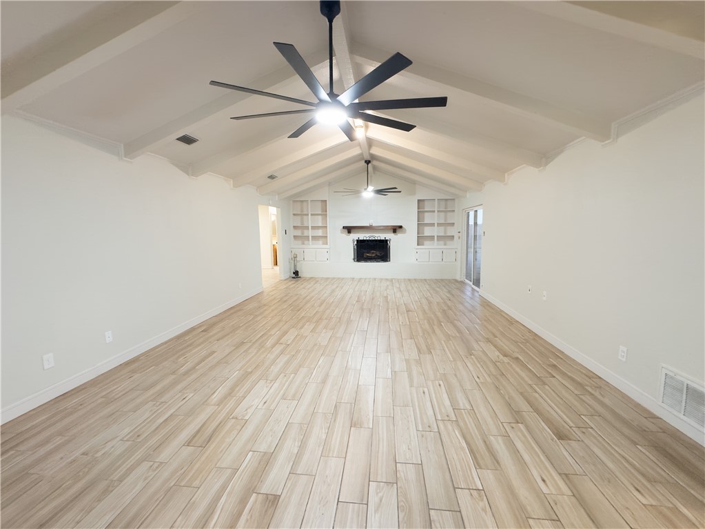 6702 Sahara Drive Corpus Christi, TX 78412 - Photo 3 of 30 wooden floor in an empty room with a window
