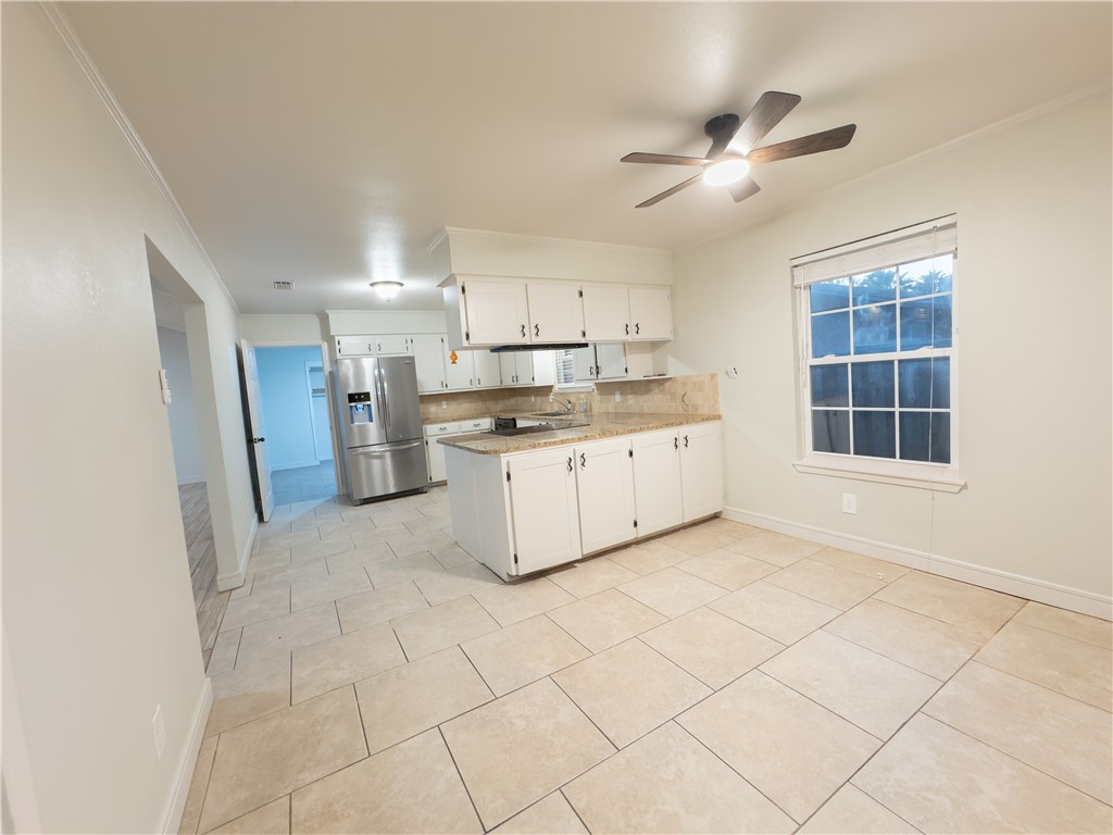 6702 Sahara Drive Corpus Christi, TX 78412 - Photo 5 of 30 a kitchen with cabinets and window