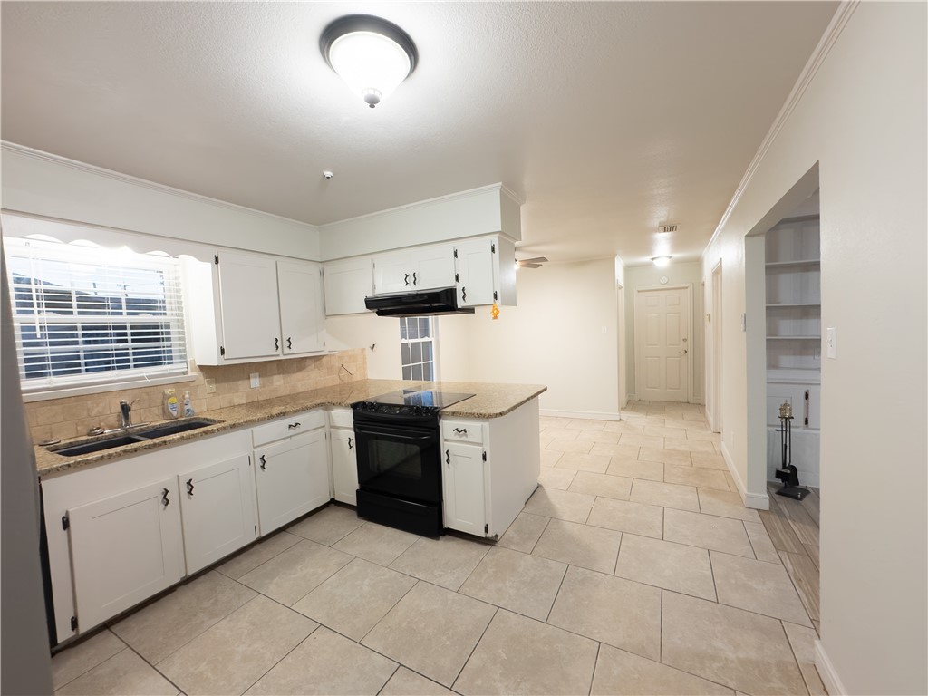6702 Sahara Drive Corpus Christi, TX 78412 - Photo 6 of 30 a kitchen with granite countertop a sink and a stove