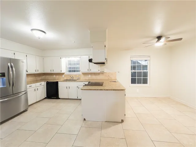 a kitchen with a stove a sink and a refrigerator