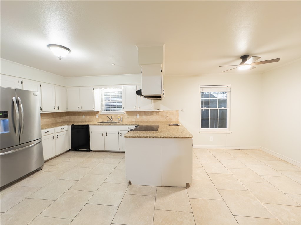6702 Sahara Drive Corpus Christi, TX 78412 - Photo 7 of 30 a kitchen with a stove a sink and a refrigerator