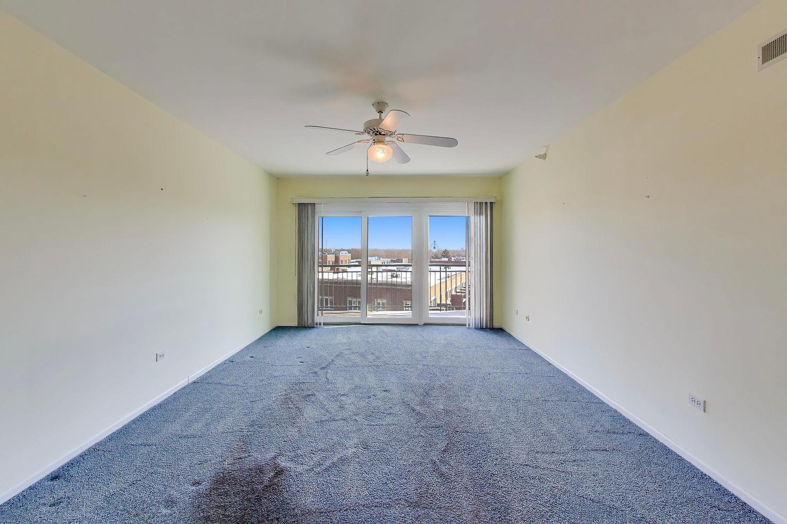 650 South River Road, Unit 812 Des Plaines, IL 60016 - Photo 13 of 25 a view of a big room with chandelier fan and windows