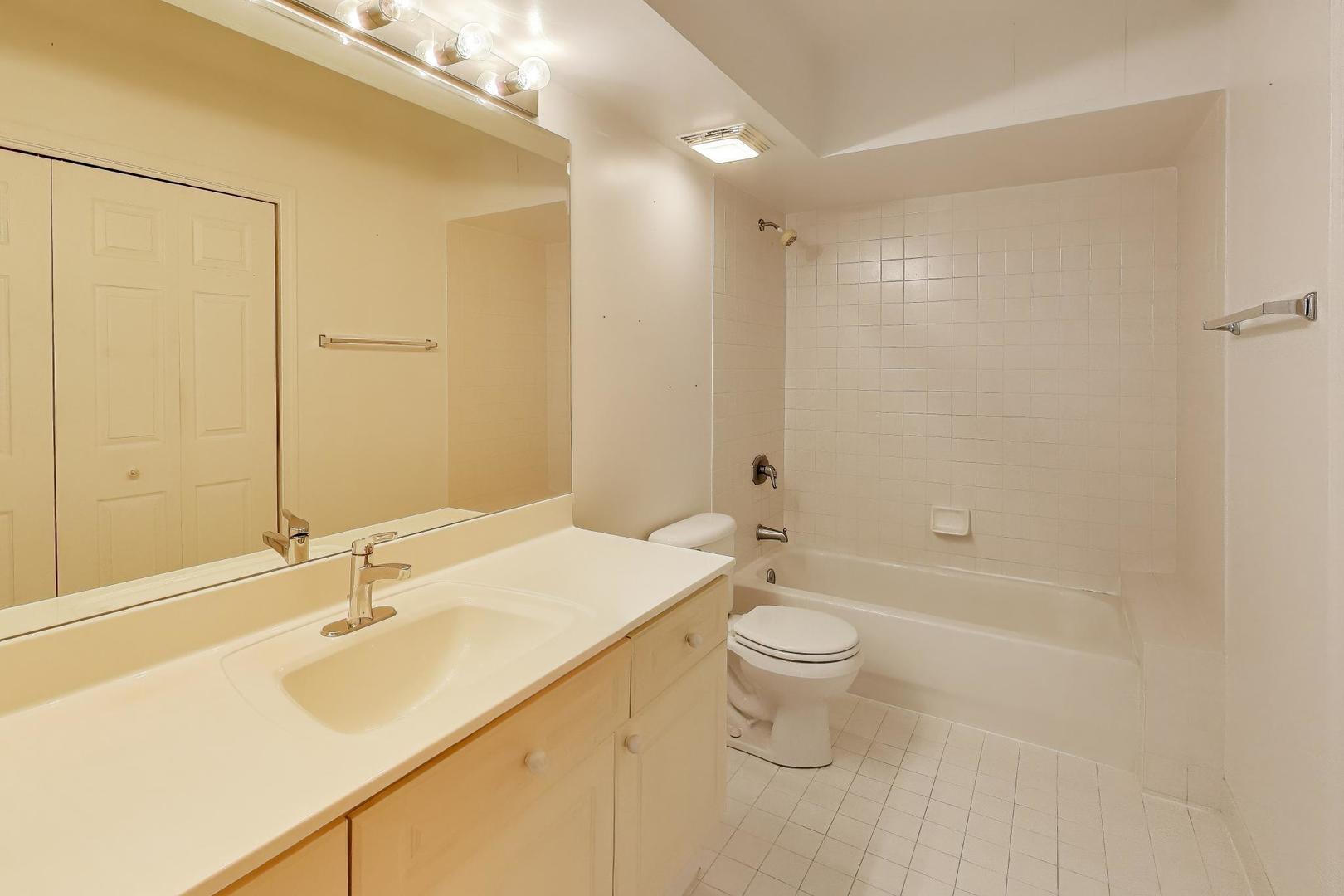 650 South River Road, Unit 812 Des Plaines, IL 60016 - Photo 16 of 25 a bathroom with a sink a toilet and shower