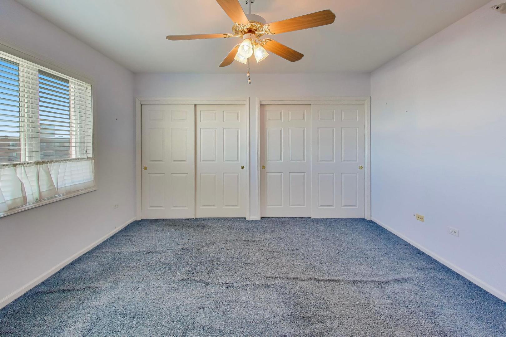 650 South River Road, Unit 812 Des Plaines, IL 60016 - Photo 20 of 25 an empty room with a window and a fan