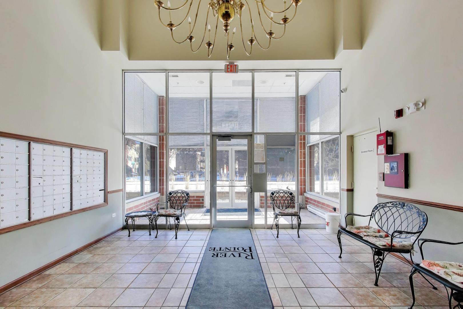 650 South River Road, Unit 812 Des Plaines, IL 60016 - Photo 4 of 25 a living room with furniture and a large window
