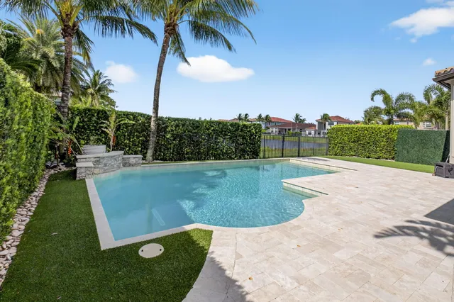 an aerial view of a house with outdoor space pool seating area and yard