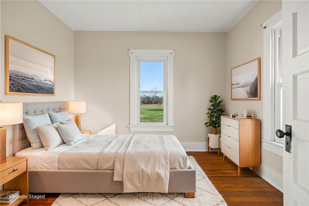 10797 Gratis Jacksonburg Road Somerville, OH 45064 - Photo 16 of 27 Bright and airy bedroom features hardwood floors and a picturesque window overlooking green landscapes.