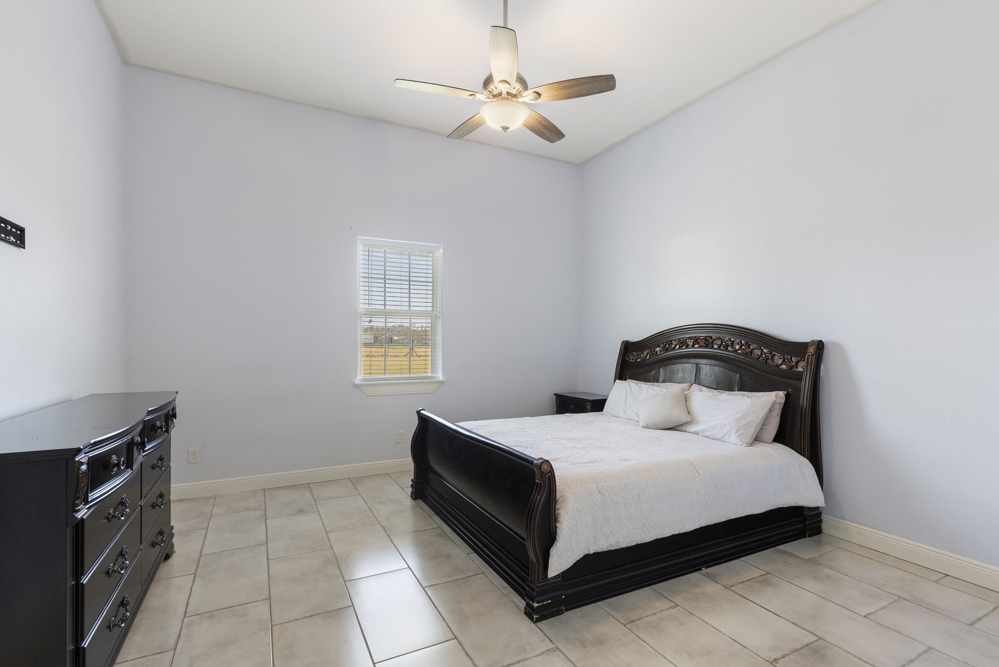 2464 North Walker Road Cleveland, TX 77328 - Photo 11 of 42 a bedroom with a bed and a ceiling fan