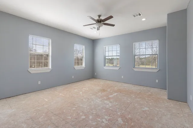 a view of a livingroom with a ceiling fan and window