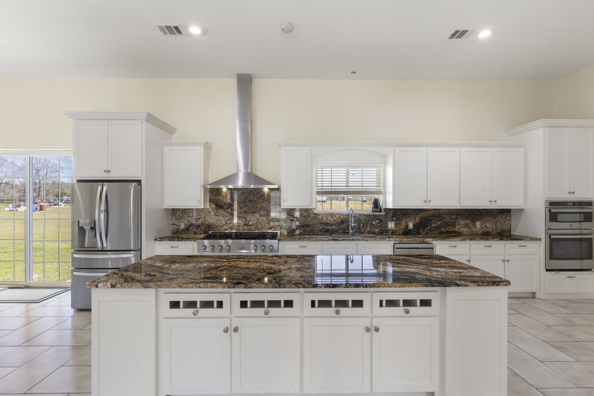 2464 North Walker Road Cleveland, TX 77328 - Photo 3 of 42 a kitchen with stainless steel appliances granite countertop a stove a sink and a refrigerator