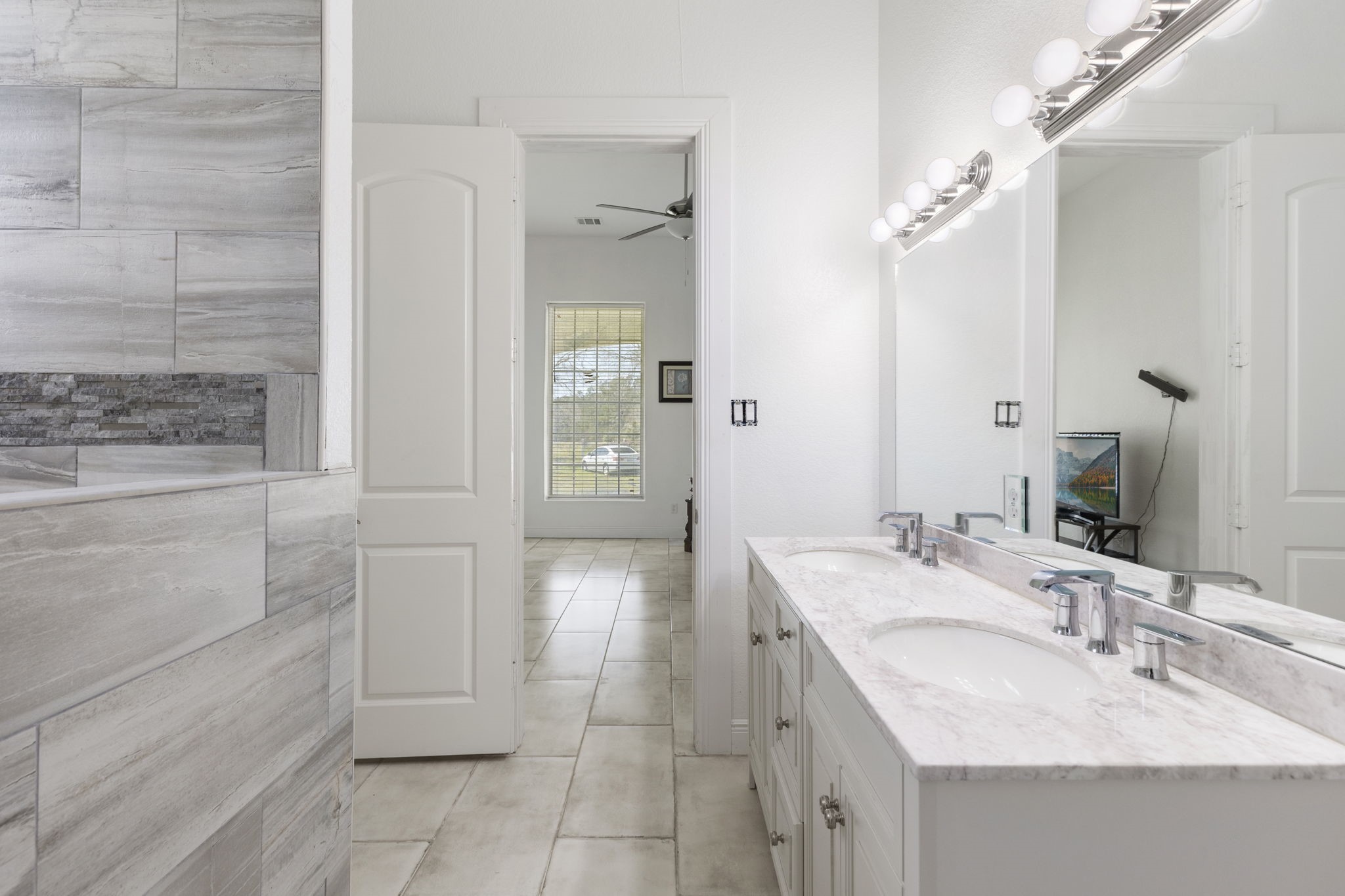 2464 North Walker Road Cleveland, TX 77328 - Photo 34 of 42 a bathroom with a sink vanity granite tub shower and a mirror