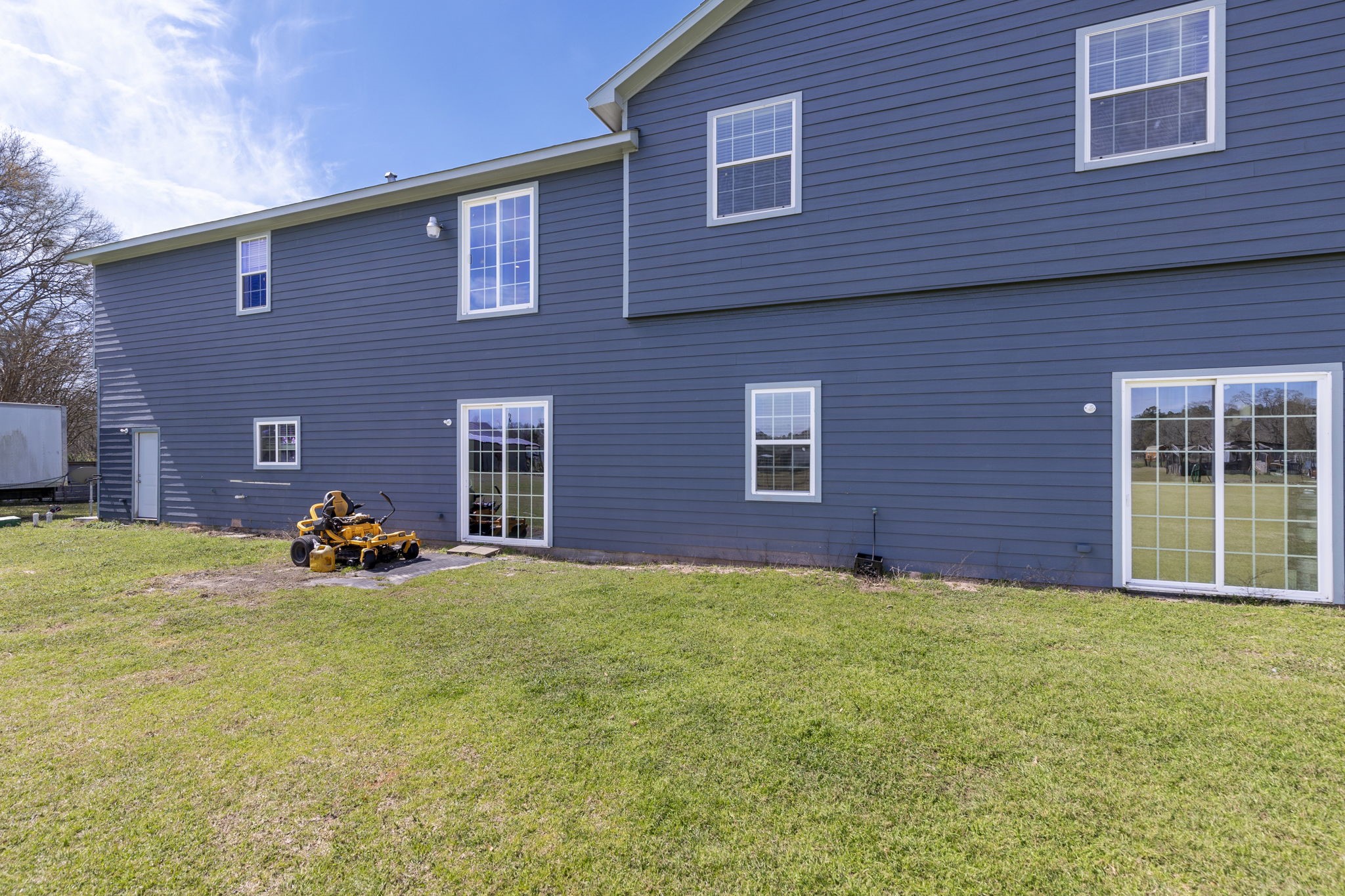 2464 North Walker Road Cleveland, TX 77328 - Photo 42 of 42 a view of a brick house with many windows and a yard