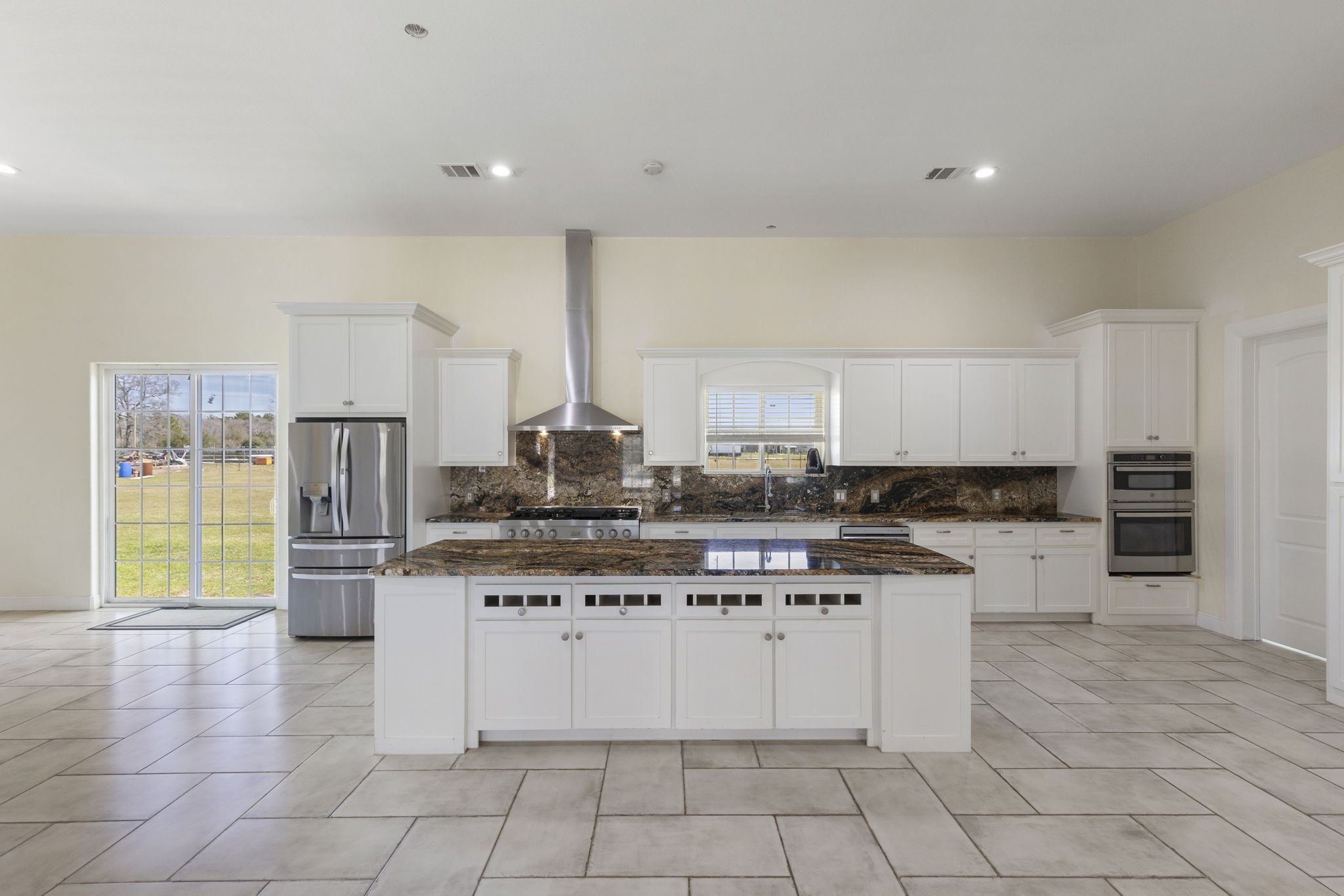 2464 North Walker Road Cleveland, TX 77328 - Photo 7 of 42 a kitchen with stainless steel appliances granite countertop a stove top oven a sink a counter top space and cabinets