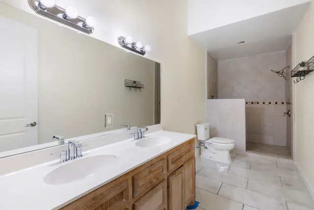 a bedroom with a bed and a ceiling fan