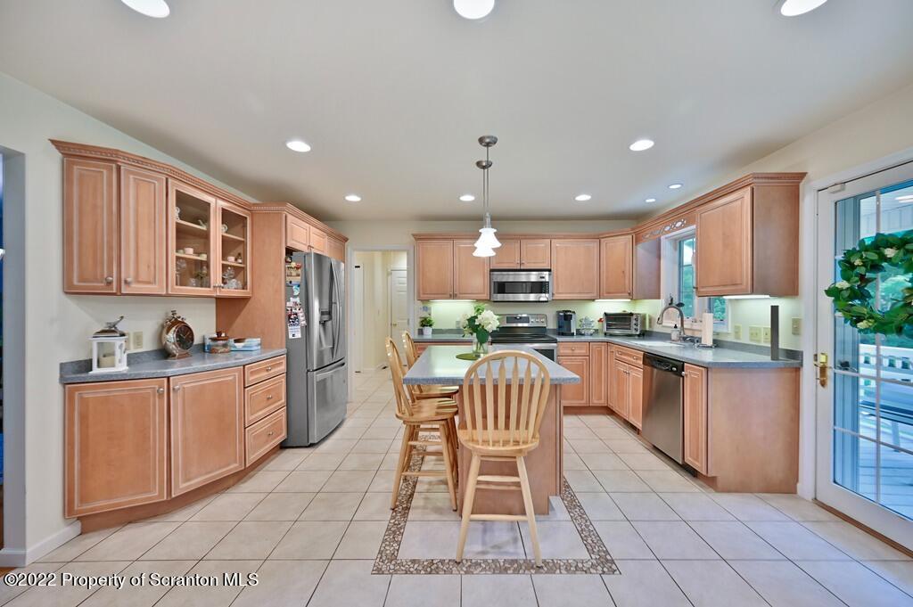 47 Wildernest Road Moscow, PA 18444 - Photo 11 of 40 a kitchen with stainless steel appliances granite countertop a stove top oven a sink dishwasher and a refrigerator