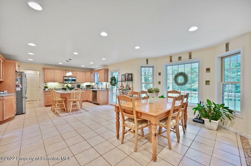 47 Wildernest Road Moscow, PA 18444 - Photo 12 of 40 a dining room with furniture and a kitchen view