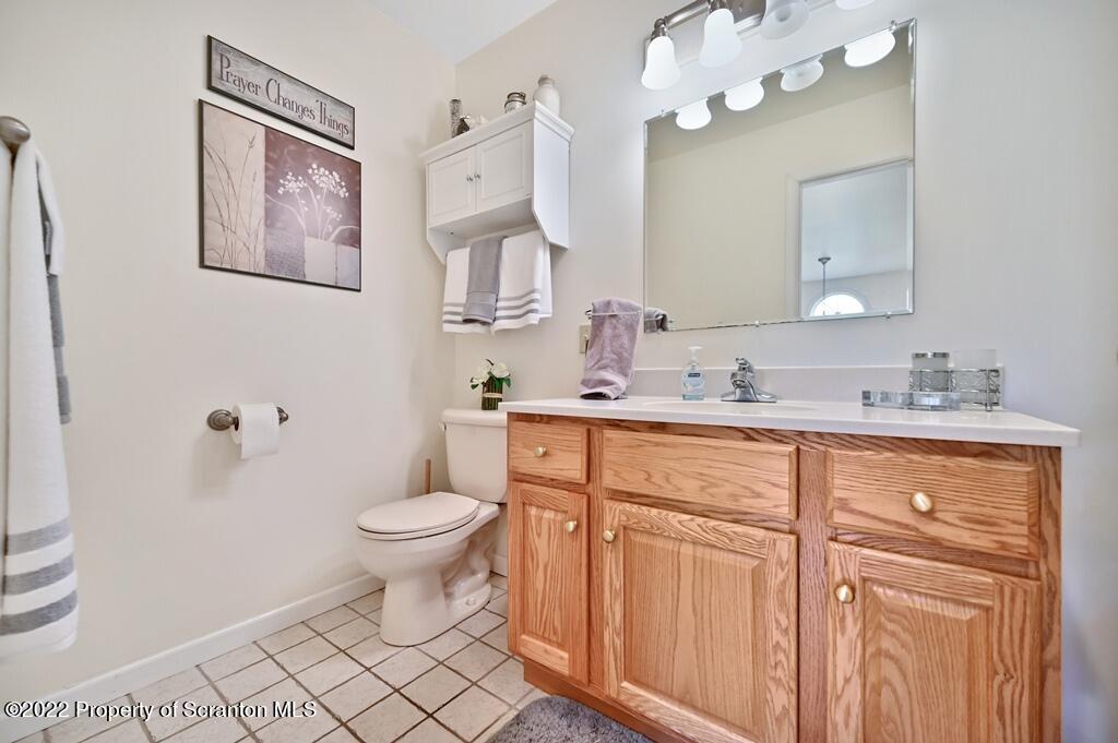 47 Wildernest Road Moscow, PA 18444 - Photo 27 of 40 a bathroom with a granite countertop sink mirror and toilet