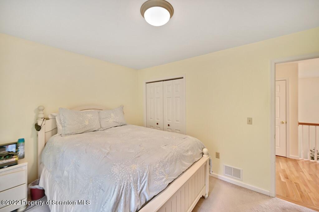 47 Wildernest Road Moscow, PA 18444 - Photo 32 of 40 a bedroom with a bed and a cabinets