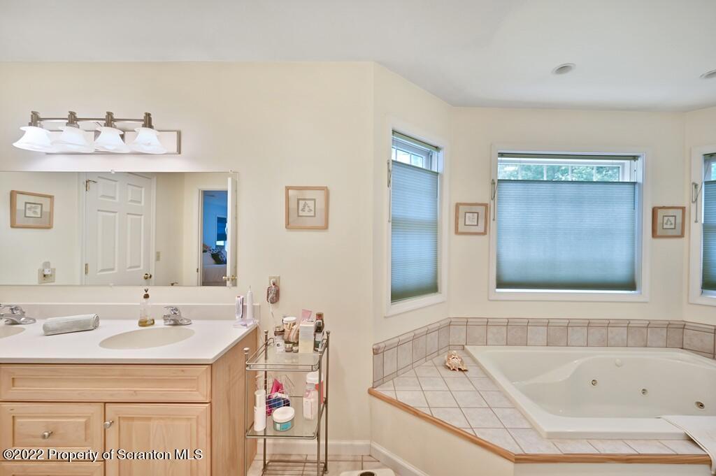 47 Wildernest Road Moscow, PA 18444 - Photo 39 of 40 a bathroom with a tub sink and mirror