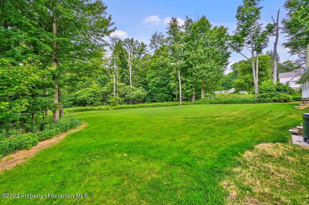 47 Wildernest Road Moscow, PA 18444 - Photo 4 of 40 a view of a grassy field with trees in the background