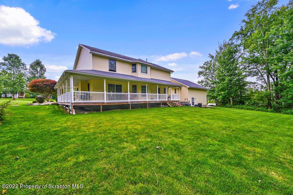 47 Wildernest Road Moscow, PA 18444 - Photo 5 of 40 a view of a house with a big yard and large trees