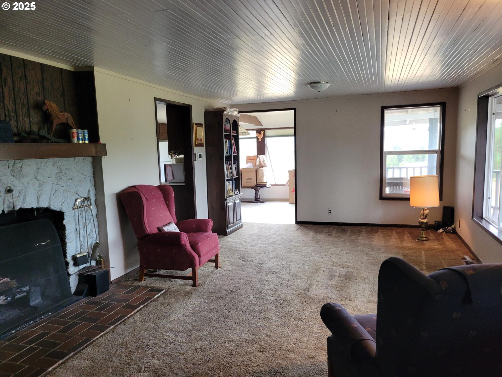 32650 Oester Road Warren, OR 97053 - Photo 31 of 43 a living room with furniture and a fireplace