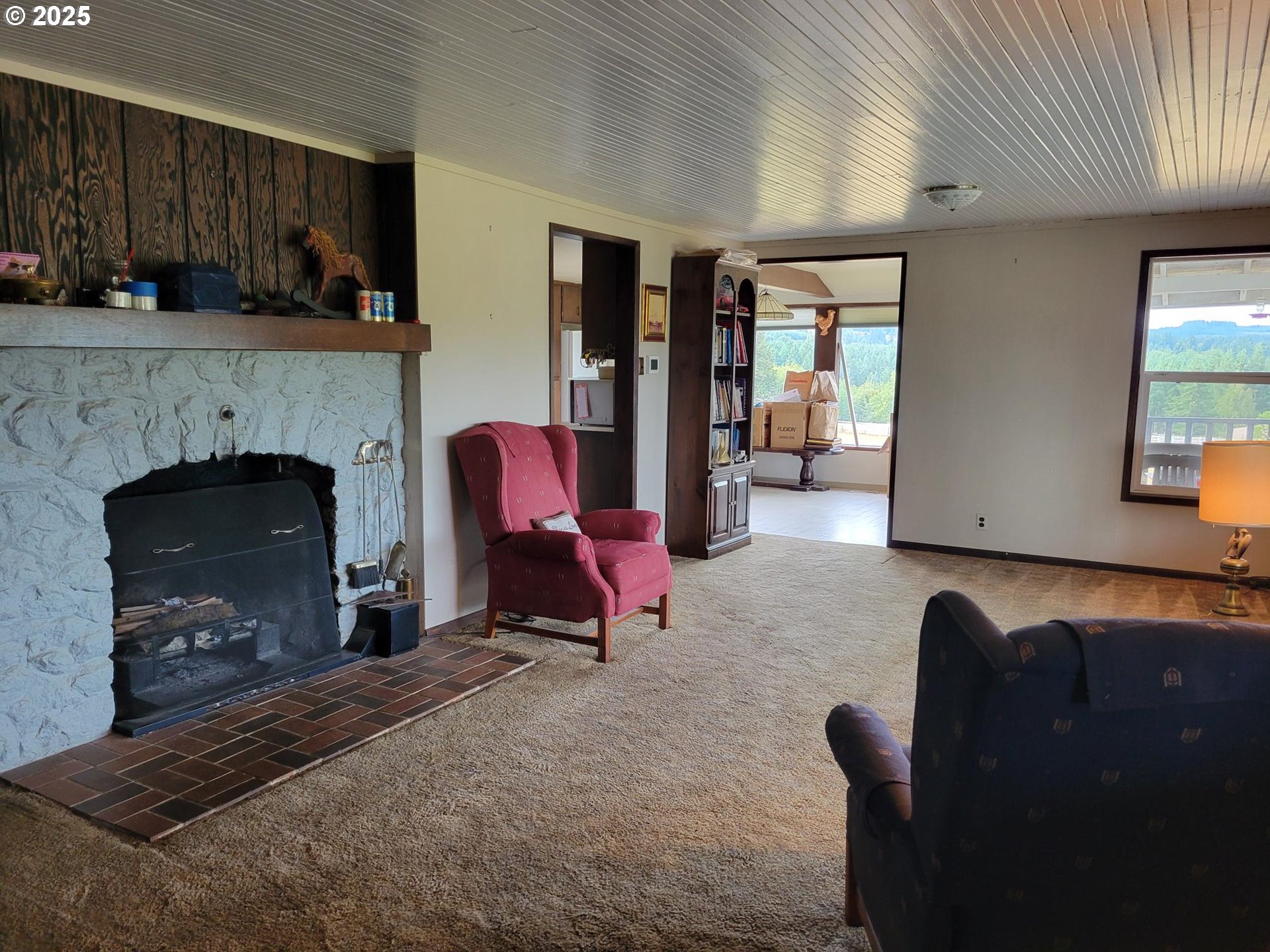 32650 Oester Road Warren, OR 97053 - Photo 32 of 43 a living room with furniture and a fireplace