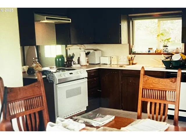 a living room with furniture and floor to ceiling window