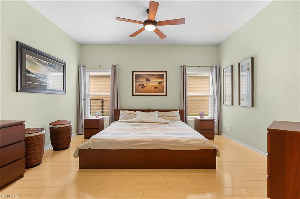2780 Orange Grove Trail Naples, FL 34120 - Photo 13 of 29 Bedroom with light wood-style floors and ceiling fan