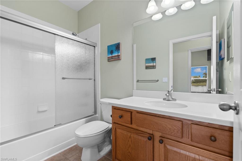 2780 Orange Grove Trail Naples, FL 34120 - Photo 20 of 29 Bathroom featuring vanity, combined bath / shower with glass door, and light tile patterned floors