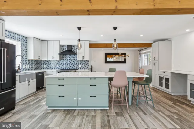 a kitchen with a table chairs refrigerator and cabinets