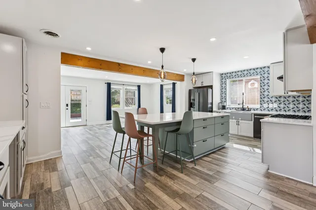 a kitchen with counter top space and wooden floor