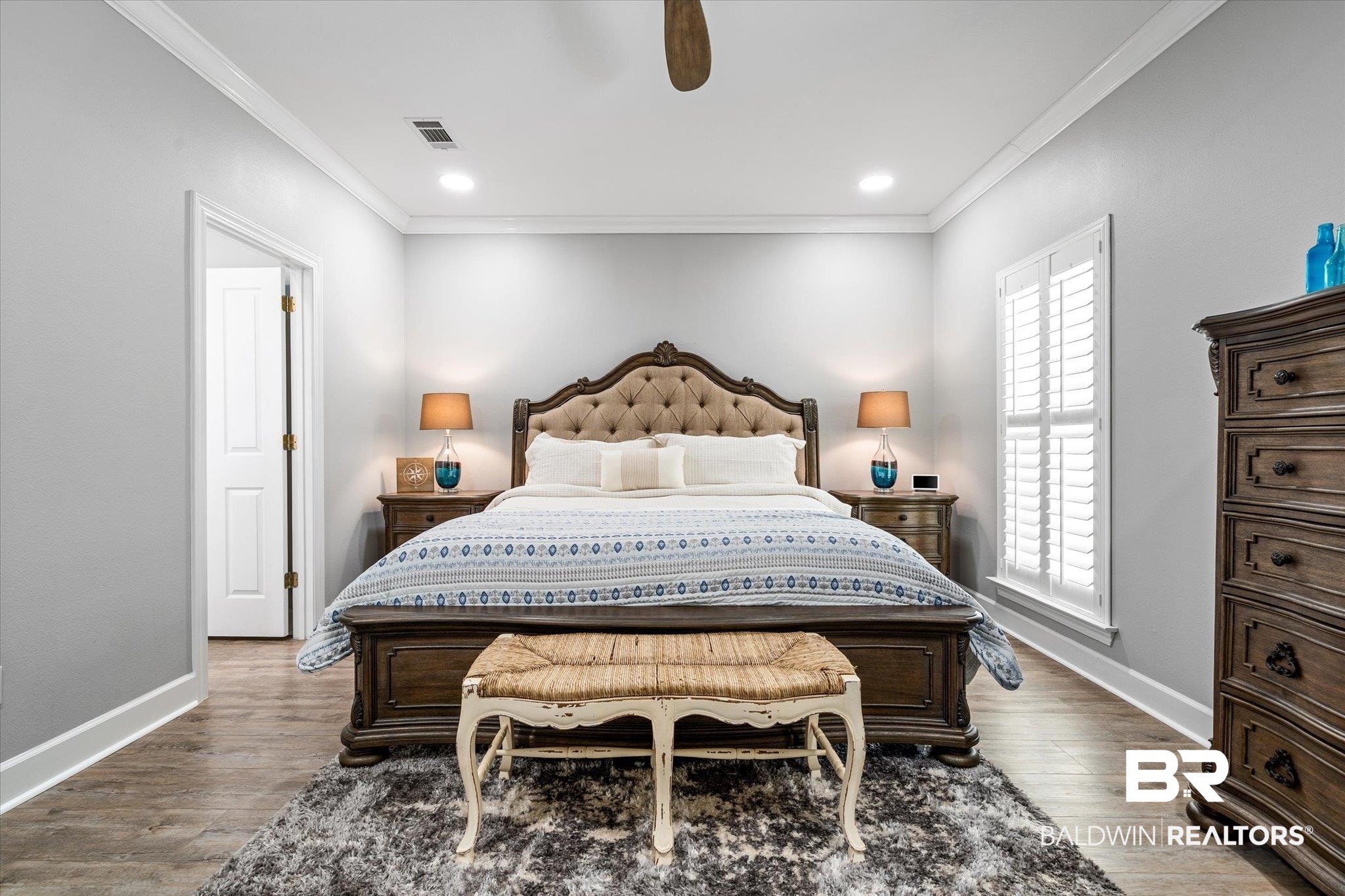 4947 Look Rook Road Orange Beach, AL 36561 - Photo 12 of 24 Bedroom with crown molding, wood finished floors, baseboards, and visible vents