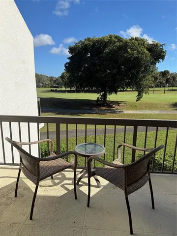 a view of a chairs and table in patio