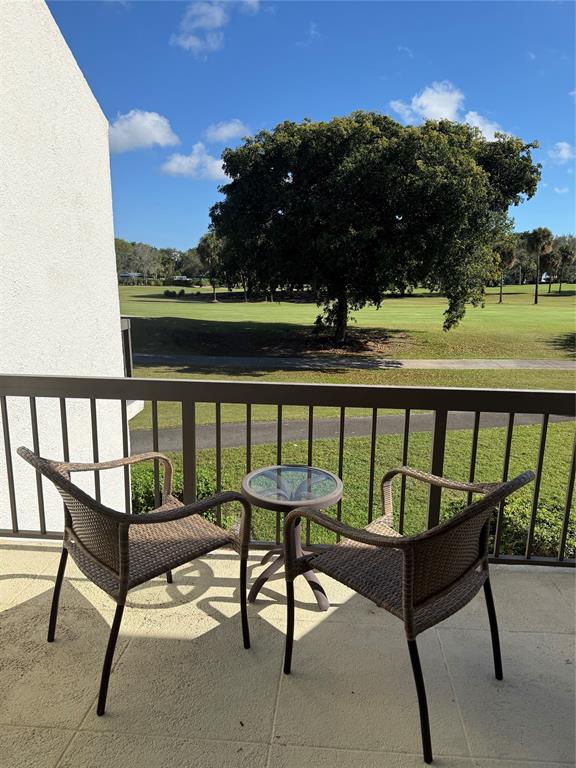 2302 Bridgewood Drive, Unit 2302 Boca Raton, FL 33434 - Photo 18 of 20 a view of a chairs and table in patio