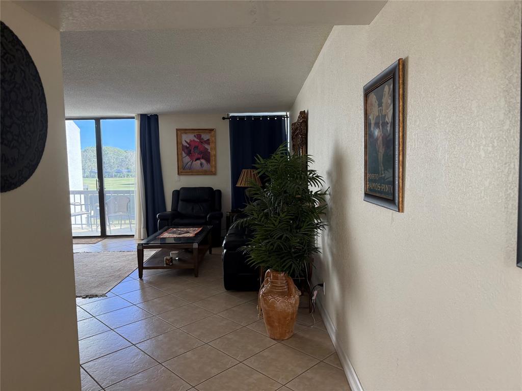 2302 Bridgewood Drive, Unit 2302 Boca Raton, FL 33434 - Photo 2 of 20 a living room with furniture and a potted plant