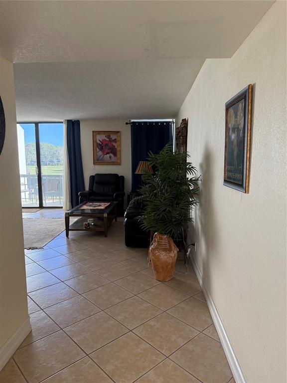 2302 Bridgewood Drive, Unit 2302 Boca Raton, FL 33434 - Photo 3 of 20 a living room with furniture and a potted plant