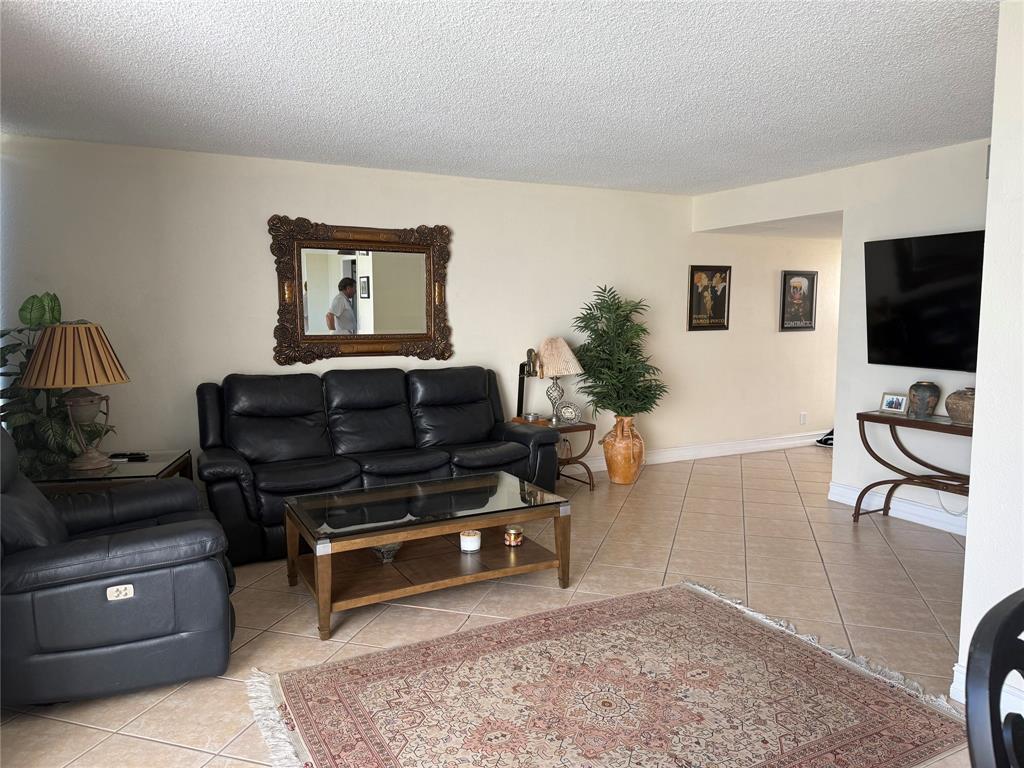 2302 Bridgewood Drive, Unit 2302 Boca Raton, FL 33434 - Photo 4 of 20 a living room with furniture and a flat screen tv