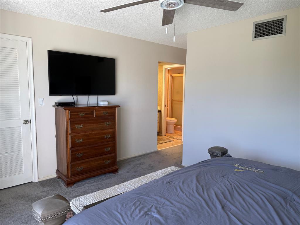 2302 Bridgewood Drive, Unit 2302 Boca Raton, FL 33434 - Photo 7 of 20 a living room with furniture and a flat screen tv