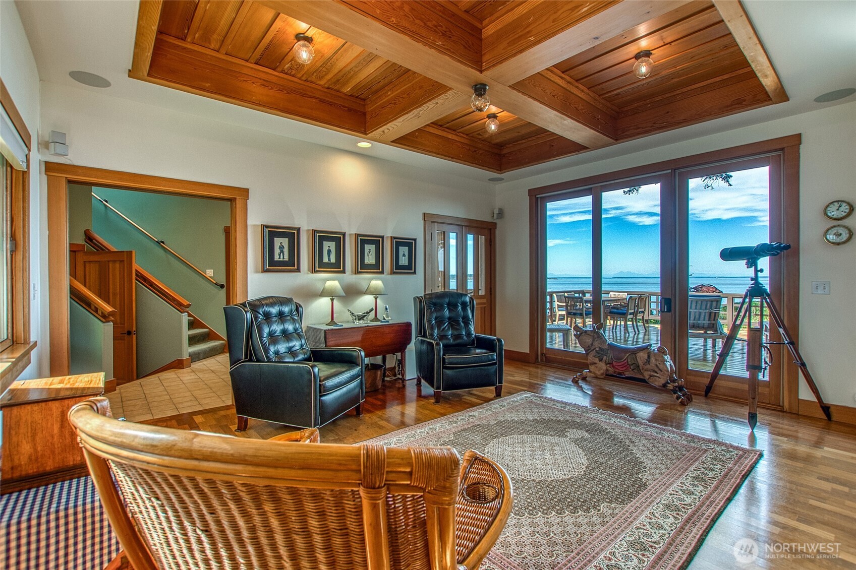 285 Raptor Road Orcas Island, WA 98245 - Photo 17 of 40 a living room with furniture a flat screen tv and a floor to ceiling window