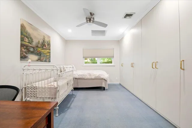 a bedroom with a bed and a couch