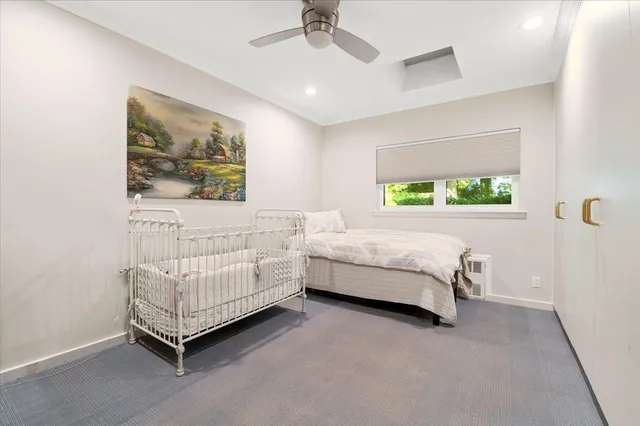 a bedroom with a bed and a painting on the wall